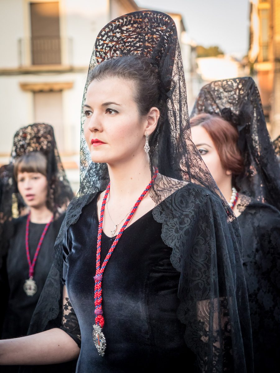 Spanish women in black dresses with mantillas and veils for Semana Santa