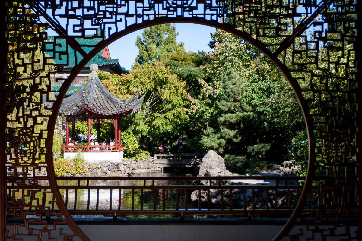 Round window into Chinese-style garden with pond