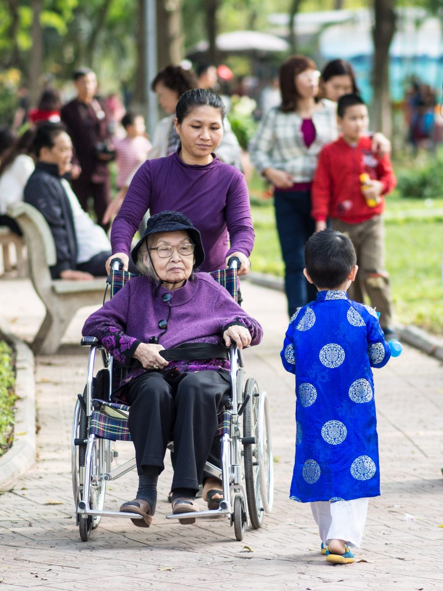 Woman in wheelchair and young boy in blue